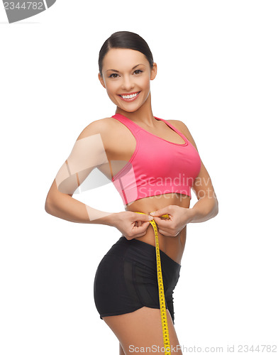 Image of sporty woman with measuring tape