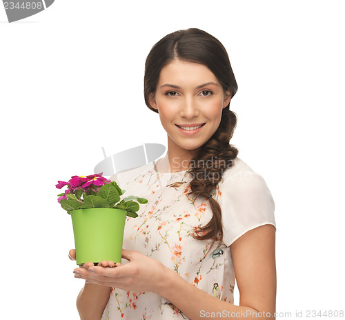 Image of lovely housewife with flower in pot