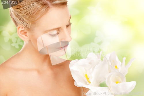 Image of lovely woman with lily flower and butterflies