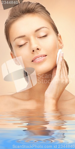 Image of beautiful woman with cotton pad