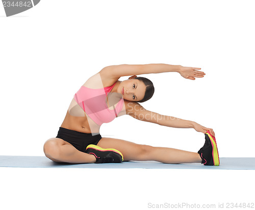 Image of sporty woman doing exercise on the floor