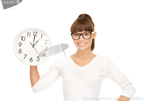 Image of businesswoman with wall clock