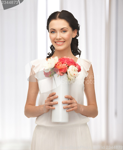 Image of woman with vase of flowers