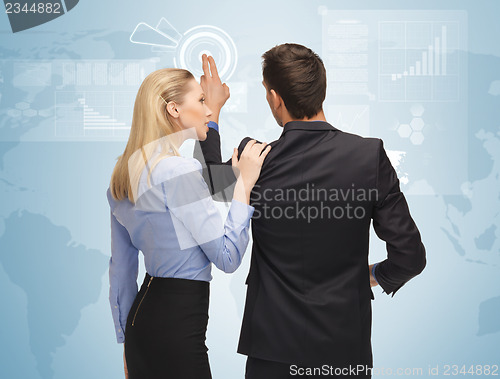 Image of man and woman working with virtual screen