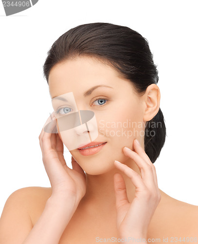 Image of woman touching her face