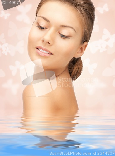 Image of beautiful woman with butterflies in water