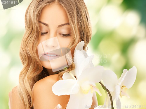 Image of beautiful woman with orchid flower
