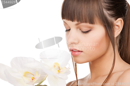 Image of lovely woman with orchid flower