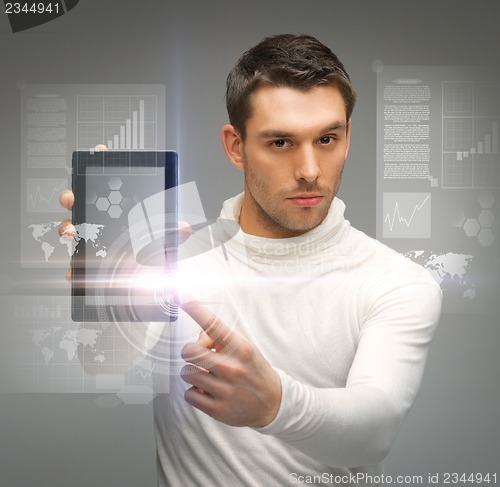 Image of man with tablet pc and virtual screens