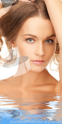 Image of beautiful woman with long hair in water