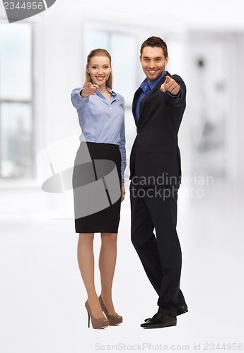 Image of man and woman pointing their fingers