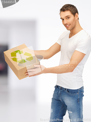 Image of handsome man with recyclable box