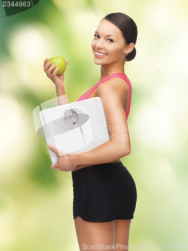 Image of woman with apple and weight scale