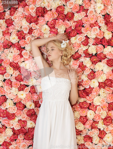 Image of young woman with background full of roses