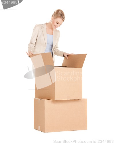 Image of businesswoman unpacking big boxes