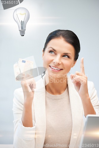 Image of woman with cash euro money and light bulb