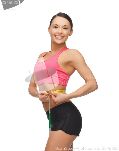 Image of sporty woman with measuring tape