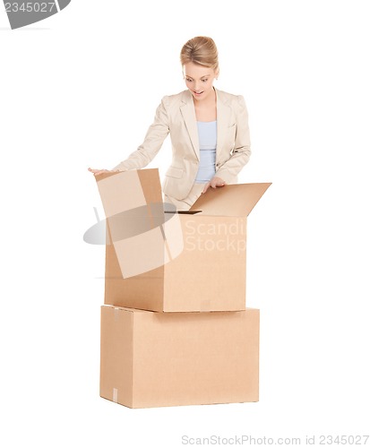 Image of businesswoman unpacking big boxes