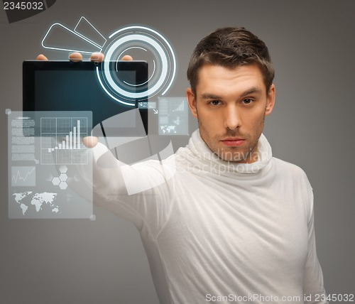Image of man with tablet pc and virtual screens