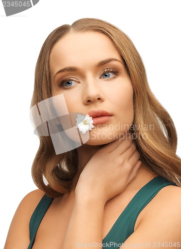Image of woman with camomile in mouth