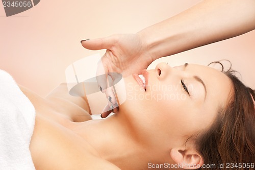 Image of beautiful woman in massage salon