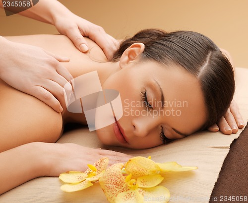 Image of beautiful woman in massage salon