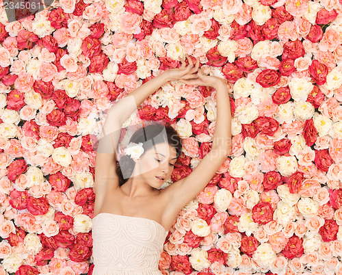 Image of young woman with background full of roses