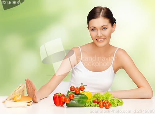 Image of woman with hamburger and vegetables