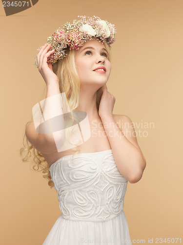 Image of woman wearing wreath of flowers