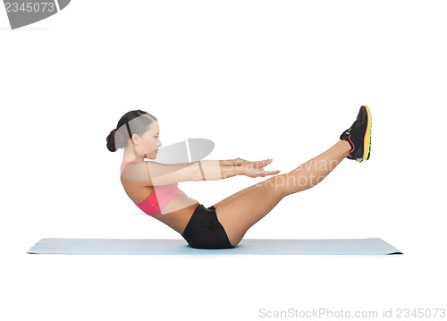 Image of sporty woman doing exercise on the floor