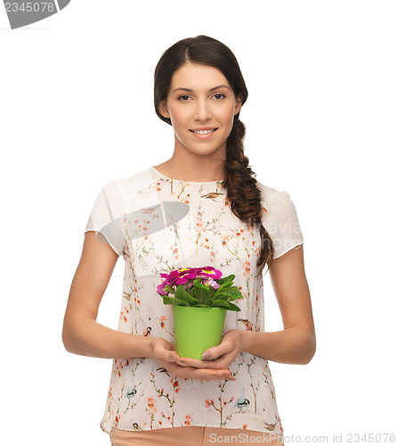 Image of lovely housewife with flower in pot