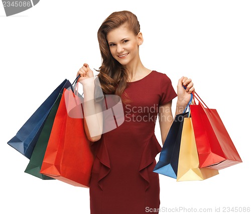 Image of teenage girl in red dress with shopping bags