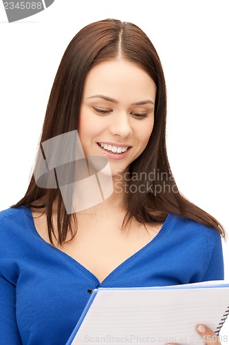 Image of smiling young businesswoman with notebook