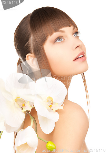 Image of lovely woman with orchid flower