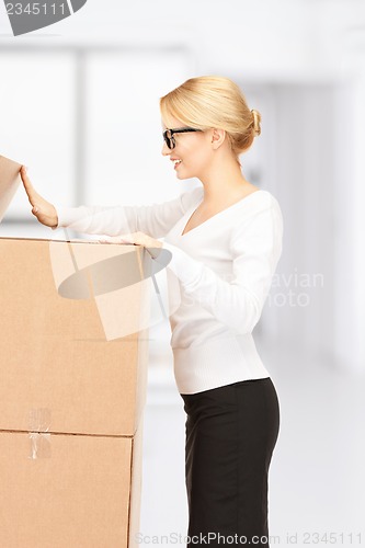 Image of attractive businesswoman with big boxes