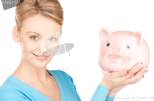 Image of lovely woman with big piggy bank