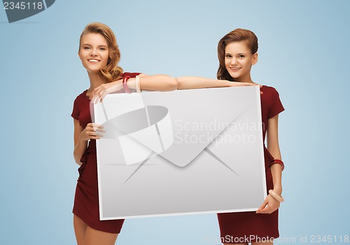 Image of girls holding big envelope