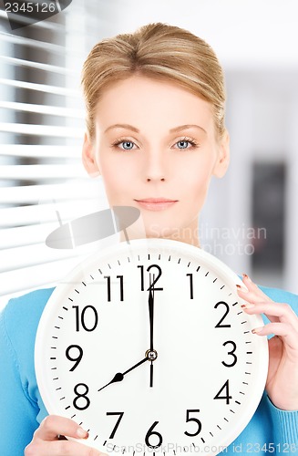 Image of woman holding big clock