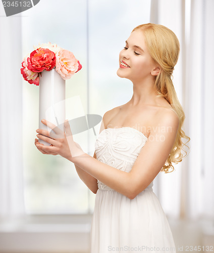 Image of woman with vase of flowers