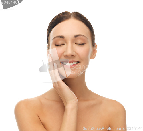 Image of beautiful woman touching her skin