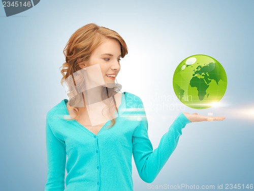 Image of woman holding green globe on her hand