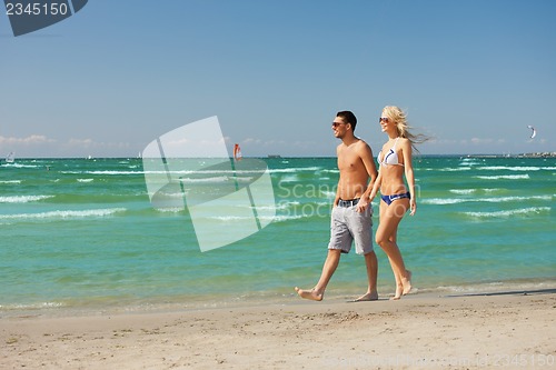 Image of couple walking on the beach