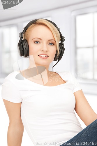 Image of happy teenage girl in big headphones
