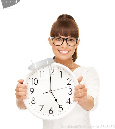 Image of businesswoman with wall clock