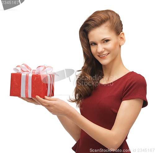 Image of teenage girl in red dress with gift box