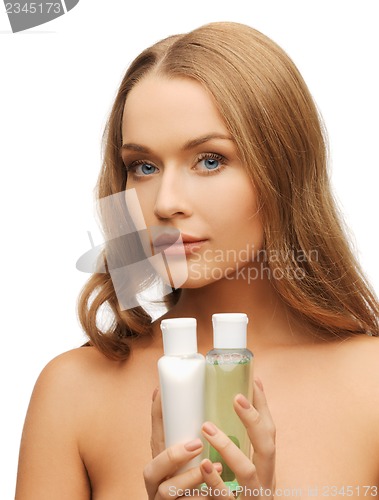 Image of woman with cosmetic bottles