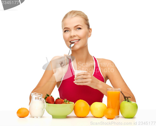 Image of young woman eating healthy breakfast