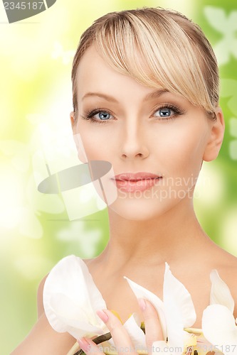 Image of beautiful woman with orchid flower and butterflies