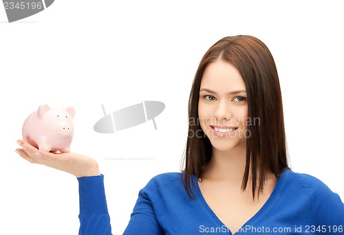 Image of lovely woman with small piggy bank