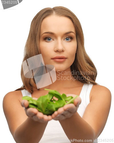 Image of woman with spinach leaves on palms